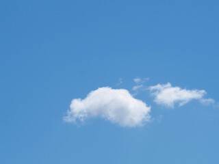 small and large cloud against the blue sky. blue background