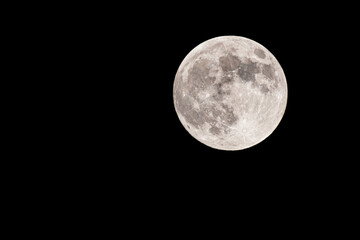 Supermoon over black night sky.May 25, 2021