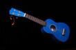 blue ukuleles on black background