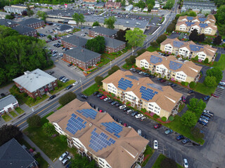 Poster - aerial view of apartment buildings with solar panel installed on roof 