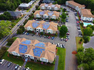 Wall Mural - aerial view of apartment buildings with solar panel installed on roof 