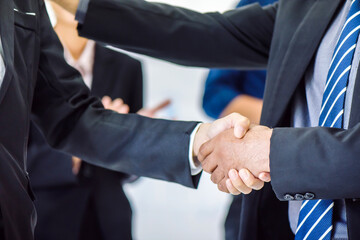 Wall Mural - Happy businessman and businesswoman with business handshake for successful of investment deal. Business cooperation and partnership in financial and marketing concept.