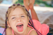 Girl Tongue Out. Having Fun Outdoors. Campground. Smiling Adorable Kid In Camp. Child Playing In Tent. Kids Camping.