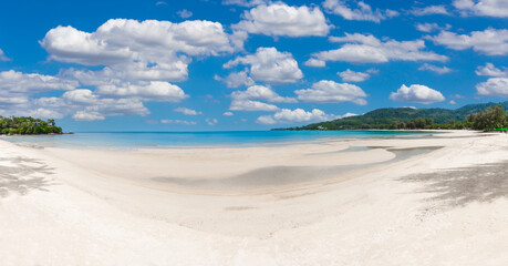 Wall Mural - tropical paradise beach with blue sky and mountain background.