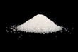 Heap of white sugar isolated on a black background. A pile of powdered white granulated sugar isolated.