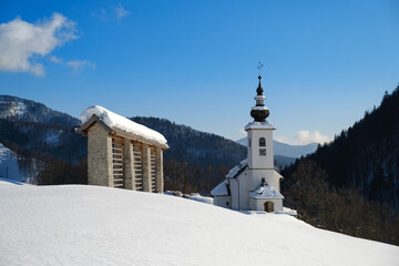 Wall Mural - Spodnje Danje mountain village with church in winter in Slovenia