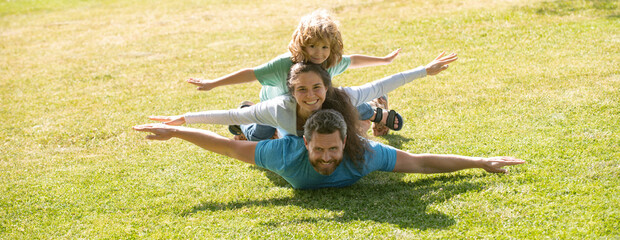 Cute family portrait. Mother father and child son having fun outdoors at summer park. Banner panorama with copy space for text.