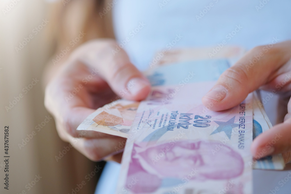 Turkish lira banknotes in woman hands. The paper currency of Turkey ...