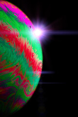 Wall Mural - Space galaxy planet. Globe earth in galaxy universe with abstract sun on black background. Color abstract fluorescent inks in water.