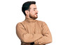 © Krakenimages.com - Young hispanic man wearing casual clothes looking to the side with arms crossed convinced and confident