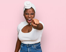 Young African Woman With Turban Wearing Hair Turban Over Isolated Background Pointing Displeased And Frustrated To The Camera, Angry And Furious With You