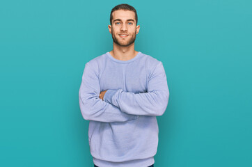 Sticker - Young caucasian man wearing casual clothes happy face smiling with crossed arms looking at the camera. positive person.