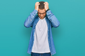 Poster - Young caucasian man wearing casual clothes suffering from headache desperate and stressed because pain and migraine. hands on head.