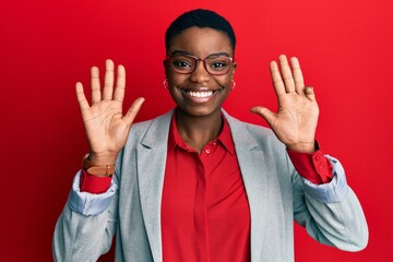 Sticker - Young african american woman wearing business jacket and glasses showing and pointing up with fingers number nine while smiling confident and happy.