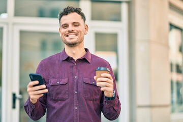 Poster - Young hispanic man using smartphone and drinking coffee at the city.