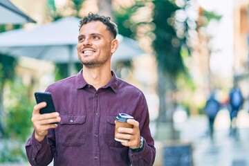 Poster - Young hispanic man using smartphone and drinking coffee at the city.