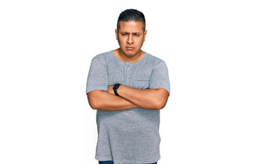 Poster - Young latin man wearing casual clothes skeptic and nervous, disapproving expression on face with crossed arms. negative person.