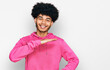 © Krakenimages.com - Young african american man with afro hair wearing casual pink sweatshirt gesturing with hands showing big and large size sign, measure symbol. smiling looking at the camera. measuring concept.
