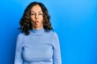 © Krakenimages.com - Middle age hispanic woman wearing casual clothes making fish face with lips, crazy and comical gesture. funny expression.