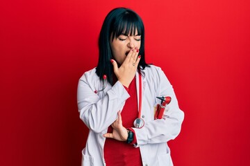 Poster - Young hispanic woman wearing doctor uniform and stethoscope bored yawning tired covering mouth with hand. restless and sleepiness.