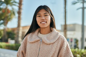 Sticker - Young asian woman smiling happy standing at the city.