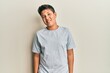 © Krakenimages.com - Teenager hispanic boy wearing casual grey t shirt winking looking at the camera with sexy expression, cheerful and happy face.