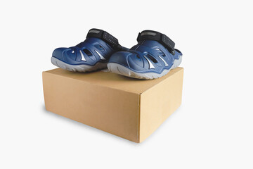 Rubber sandals over a Carton packaging box isolated on the white background.