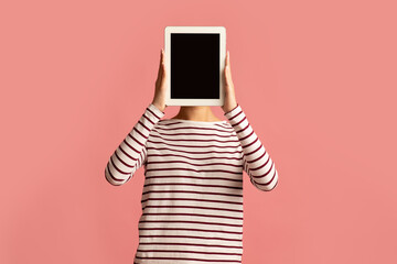 Wall Mural - Unrecognizable Young Female Covering Face With Digital Tablet With Black Blank Screen