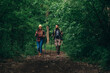 © Zamrznuti tonovi - Couple of hikers using trekking poles while wearing backpacks