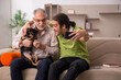 © Elnur - Two men with dog at home