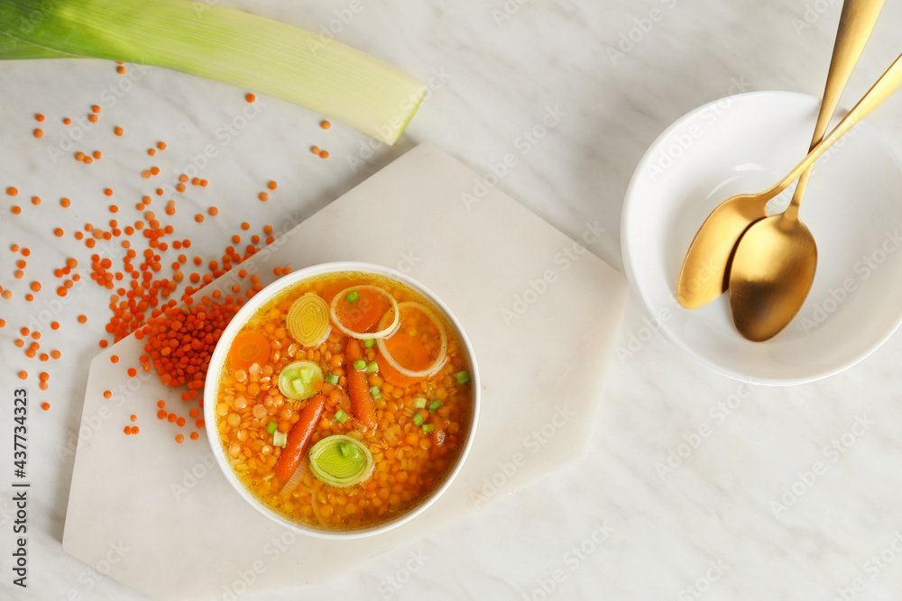 Bowl of tasty lentil soup on table