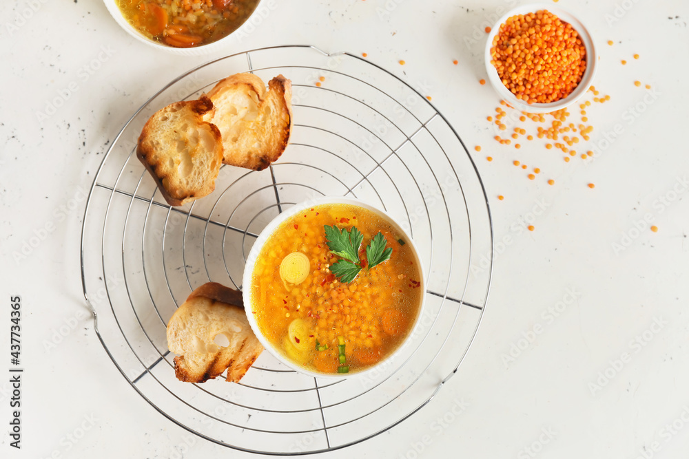 Bowl of tasty lentil soup on table