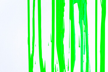 Wall Mural - Paint streams on a  light green surface. A background with  strips from color. Vertical streams of  paint. Background abstract structure