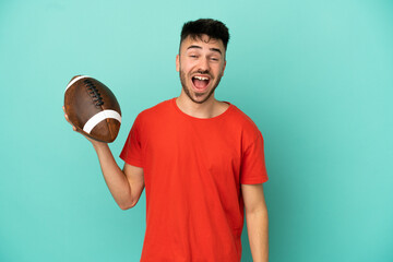 Wall Mural - Young Caucasian man playing rugby isolated on blue background with surprise facial expression