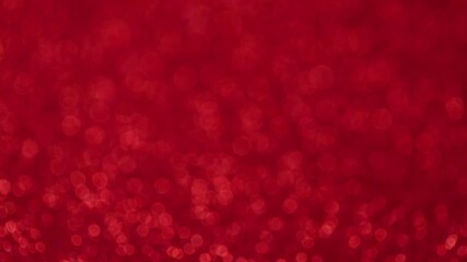 Red bokeh background. Circular motion on shiny red background. Defocus. Close-up, top view.