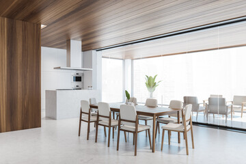 Modern office corner with long dining tables and white chairs