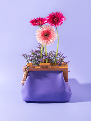 Canvas Print - Purple leather fashion handbag with pink gerbera, summer accessory concept