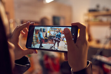 Poster - Female hand with smartphone during video shooting of music performance