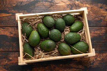 Wall Mural - Fresh avocado in wooden box on rustic table