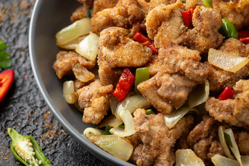 Wall Mural - Stir fry chinese salt and pepper chicken with rice in grey bowl