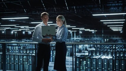 Poster - Data Center Female e-Business Enrepreneur and Male IT Specialist talk, Use Laptop. Two Information Technology Engineers work on Bridge Big Cloud Computing Server Farm. Tracking Wide Zoom in Two Shot