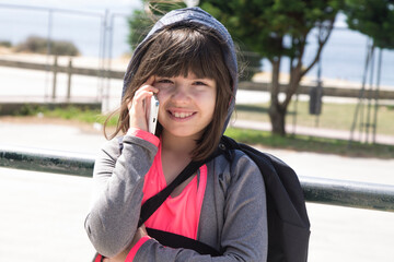 Wall Mural - student girl with backpack using mobile phone