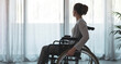 © StockPhotoPro - Woman in wheelchair at home alone