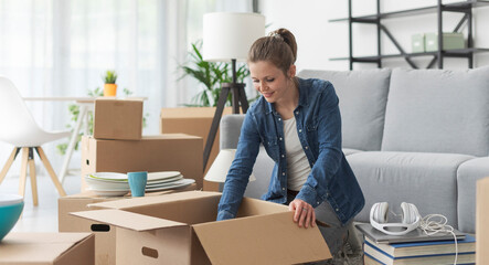 Wall Mural - Woman unpacking in her new apartment