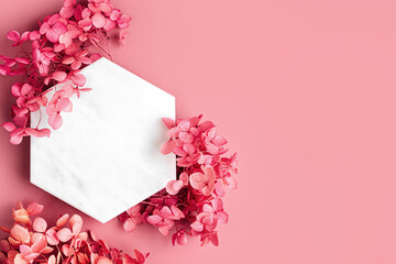 Wall Mural - marble hexagon on pink background with flowers. stylish background for presentation.
