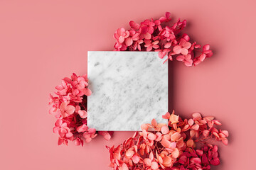Wall Mural - square marble plate on pink background with flowers. stylish background for presentation.