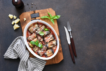 Wall Mural - Roll with eggplant and ricotta in tomato juice with parmesan. Baked eggplant with sauce and basil. View from above.