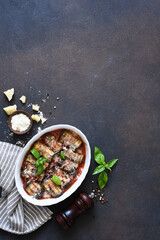 Wall Mural - Roll with eggplant and ricotta in tomato juice with parmesan. Baked eggplant with sauce and basil. View from above.