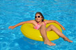 © SuperCoolPhotography - Real adorable girl relaxing in swimming pool