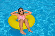 © SuperCoolPhotography - Real adorable girl relaxing in swimming pool